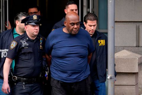 Law enforcement officials lead subway shooting suspect Frank James away from a police station in New York on Wednesday, April 13. James was arrested Wednesday and charged with a federal offense.