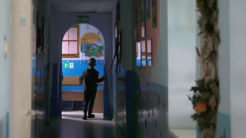 A child walks down a hallway in an orphanage in Lviv, Ukraine, that houses 40 children ages 3 to 18. Lviv has served as a stopover and shelter for Ukrainians fleeing the Russian invasion, either to the safety of nearby countries or the relative security of western Ukraine.