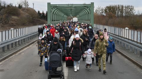 Ukrainian refugees cross a bridge in Ukraine near the Polish border on March 6, 2022.