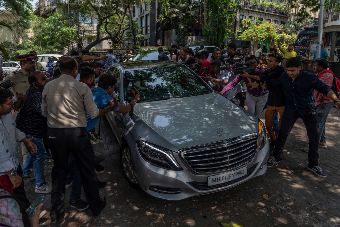 Members of the media jostle for photographs and footage of guests arriving to attend a function ahead of Kapoor and Bhatt's wedding.