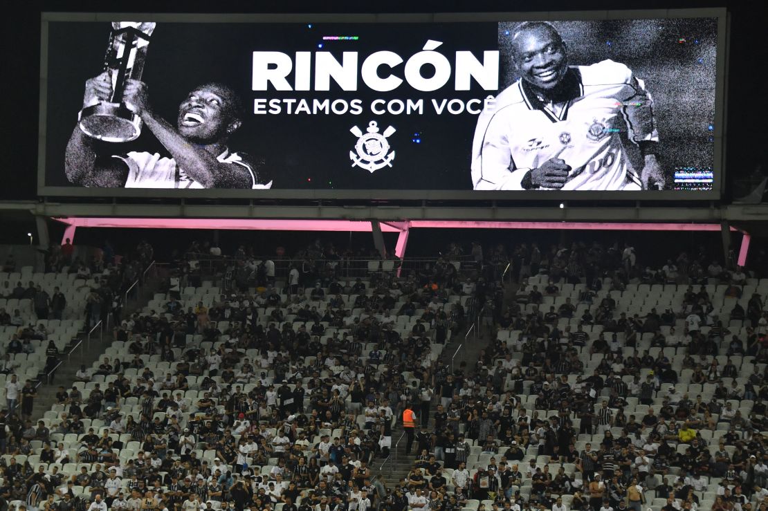 A screen projects an image of former Colombian star midfielder Freddy Rincón reading "Rincón We Are With You" during the Copa Libertadores group stage first leg football match between Brazil's Corinthians and Colombia's Deportivo Cali at the Corinthians Arena in Sao Paulo, Brazil, on April 13, 2022. 