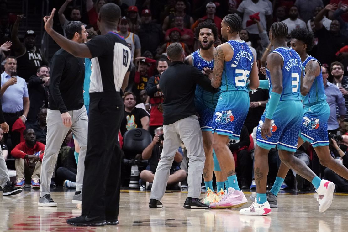 Bridges (0) is restrained by P.J. Washington (25) and others as he argues with an official after being charged with a foul.