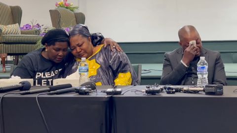 Patrick Lyoya's parents, Peter Lyoya, right, and Dorcas Lyoya, middle, weep during a community forum in Grand Rapids, Michigan.