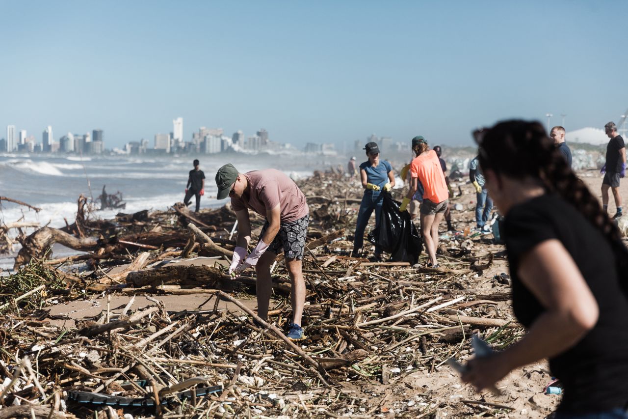 Volunteers work to clean up debris at the Blue Lagoon beach in Durban on April 14.