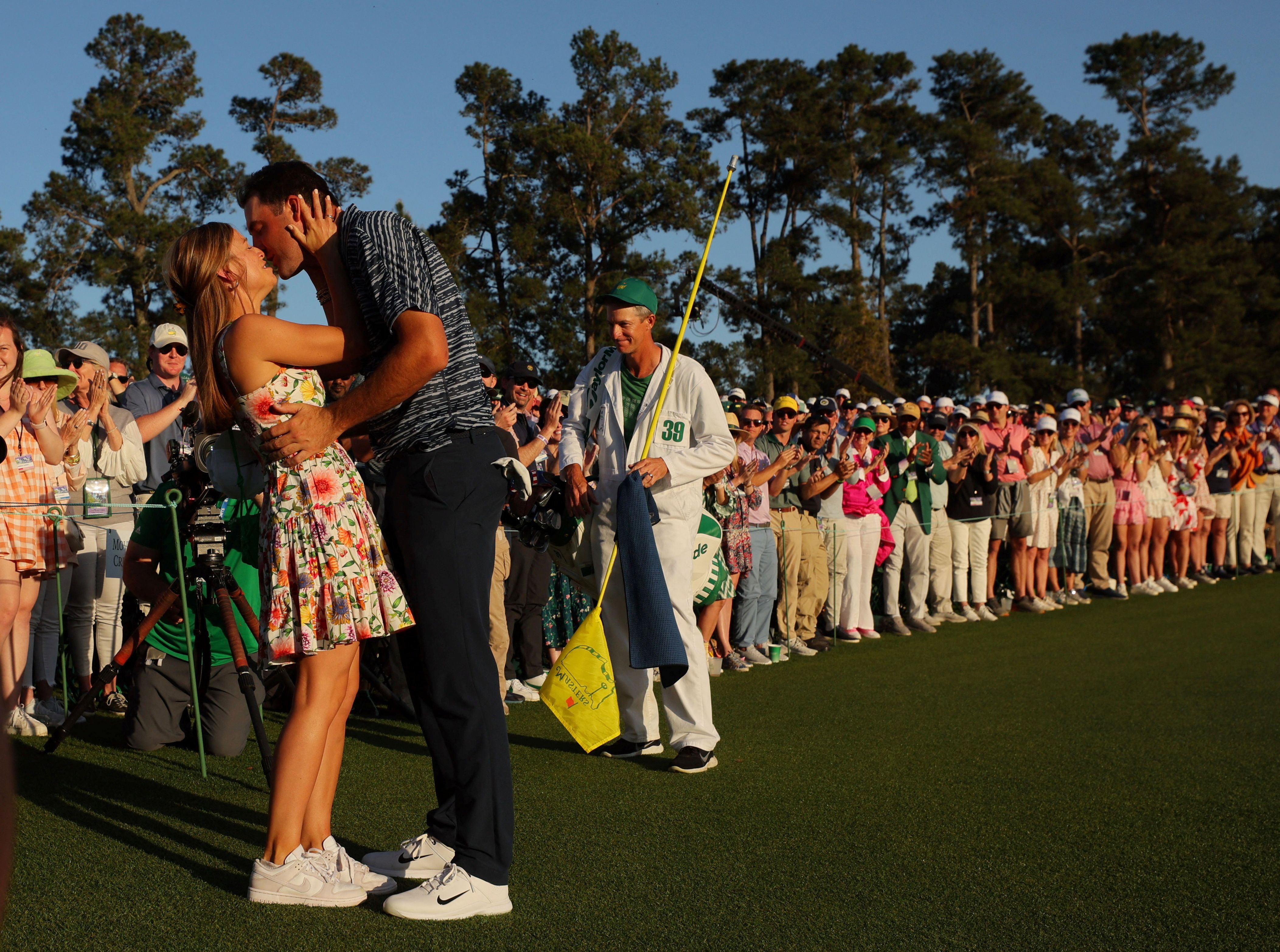 Scottie Scheffler kisses his wife, Meredith, after winning the Masters golf tournament on Sunday, April 10.