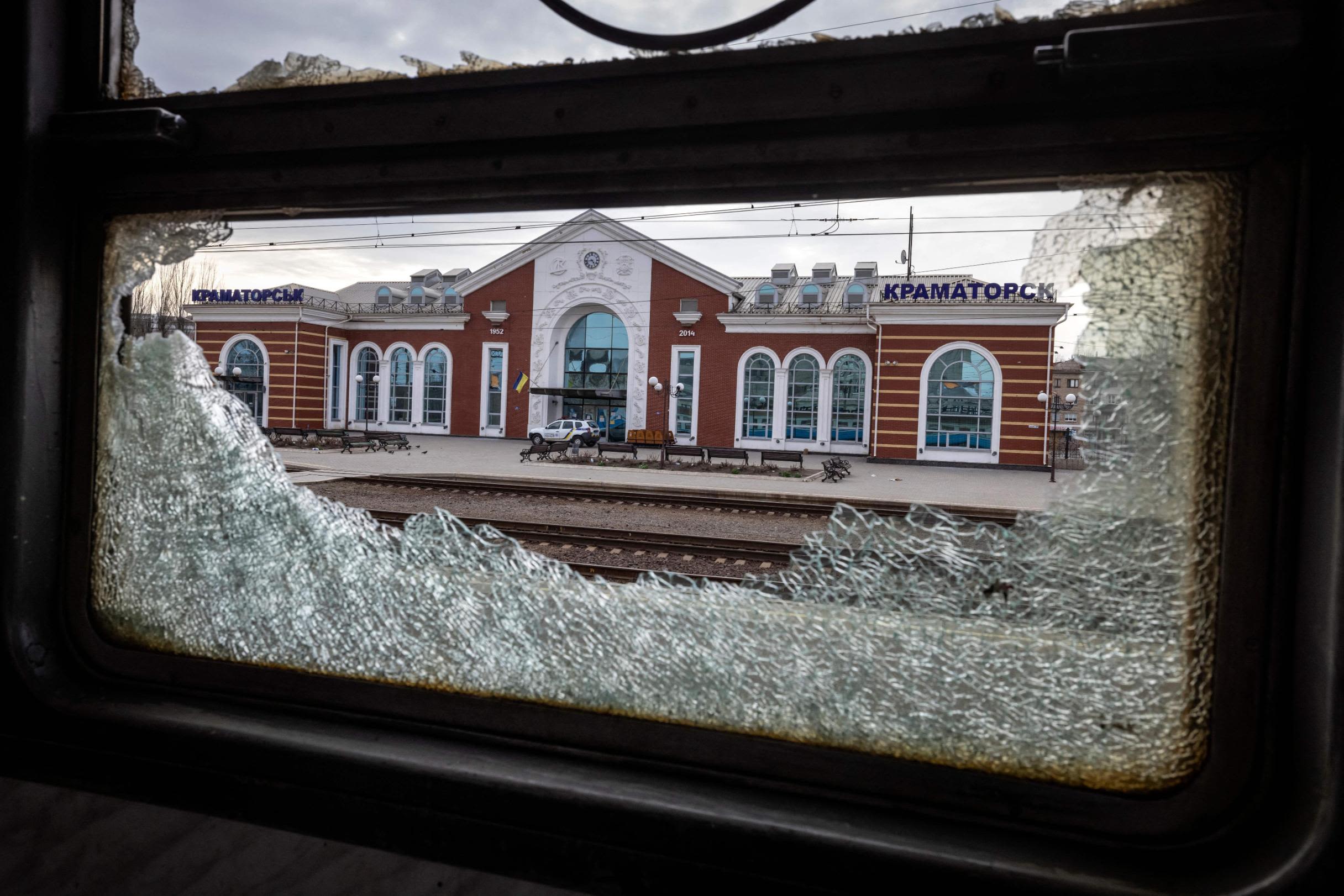 A train car's window is damaged after a train station was struck by Russian forces in Kramatorsk, Ukraine, on Friday, April 8.