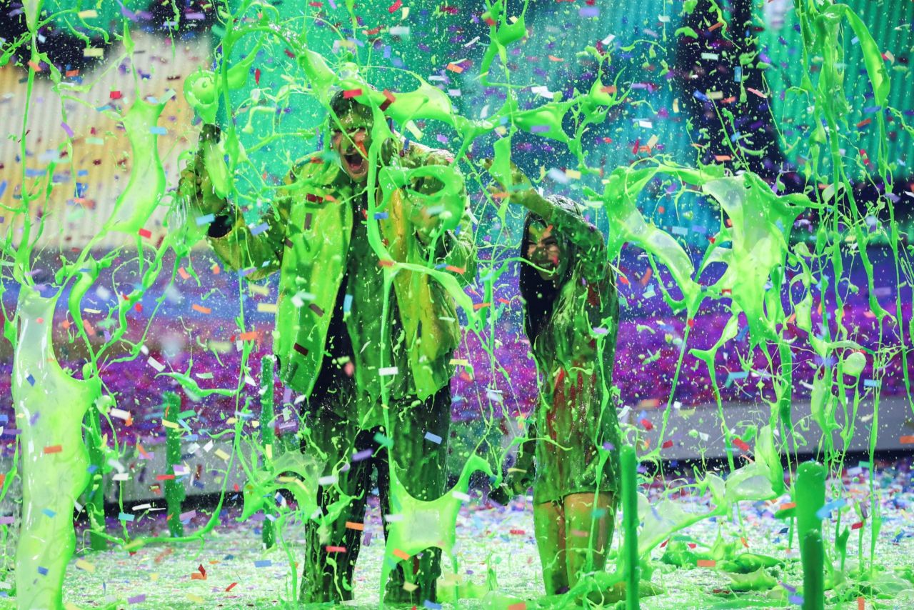 Hosts Miranda Cosgrove and Rob Gronkowski get slimed during the Nickelodeon Kids' Choice Awards on Saturday, April 9.