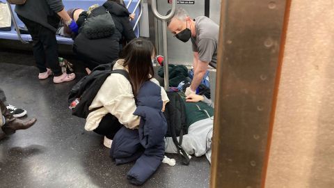 Wounded commuters are given first aid after a <a href="http://www.cnn.com/2022/04/12/us/gallery/brooklyn-subway-shooting/index.html" target="_blank">shooting on a subway train</a> in New York City on Tuesday, April 12.