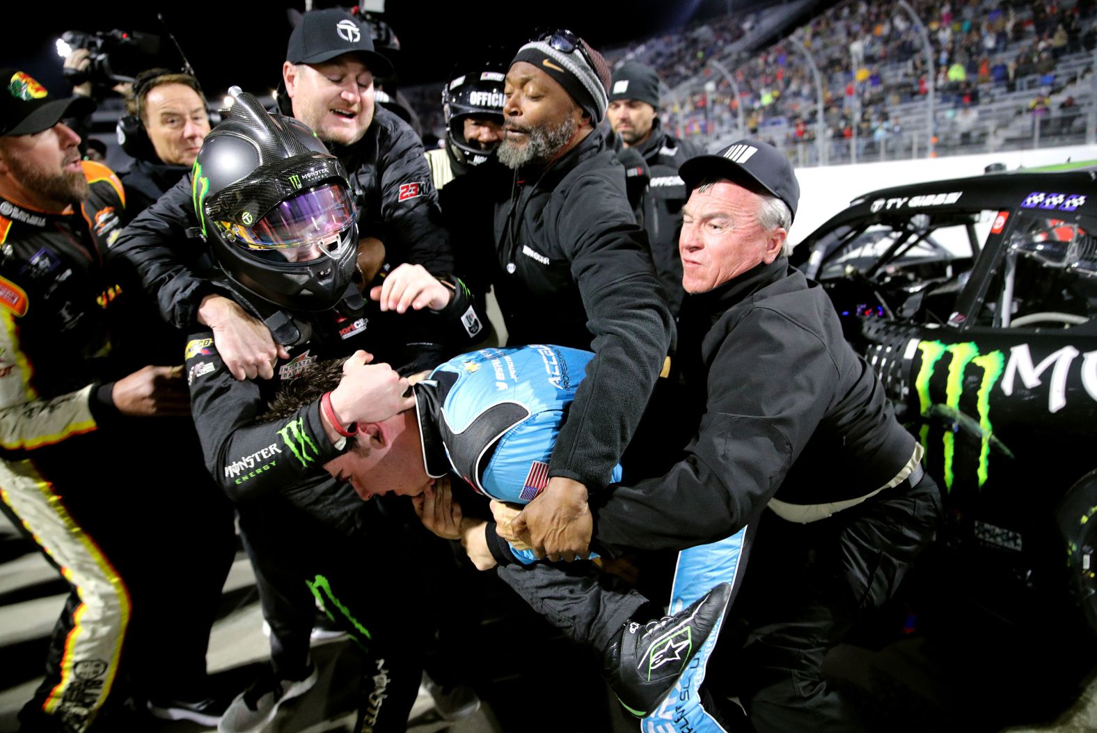 Crew members break up a fight between NASCAR drivers Sam Mayer, bottom right, and Ty Gibbs on Friday, April 8. <a href="index.php?page=&url=https%3A%2F%2Fbleacherreport.com%2Farticles%2F10032140-video-ty-gibbs-sam-mayer-trade-punches-in-fight-at-nascar-xfinity-series-race" target="_blank" target="_blank">The two tangled</a> after the Xfinity Series race in Martinsville, Virginia.