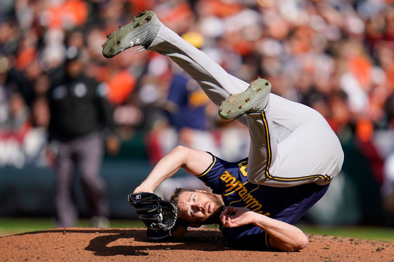 Milwaukee pitcher Adrian Houser rolls onto his back after catching a ball hit by Baltimore's Austin Hays during a Major League Baseball game in Baltimore on Monday, April 11.