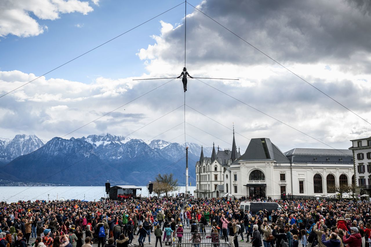 A tightrope walker crosses the market square of Vevey, Switzerland, on Saturday, April 9.