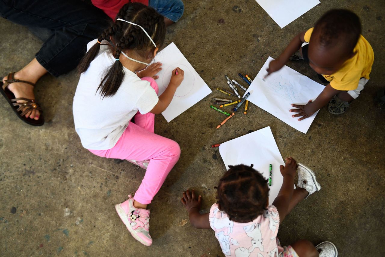 Children draw with crayons at a shelter for migrants in Tijuana, Mexico, on Saturday, April 9. As the United States <a href="http://www.cnn.com/2022/04/14/world/gallery/ukrainians-us-mexico-border/index.html" target="_blank">rolls out the welcome mat</a> for Ukrainian refugees, <a href="https://www.cnn.com/2022/03/29/us/ukrainians-us-mexico-border-cec/index.html" target="_blank">some see a double standard</a> at the border.