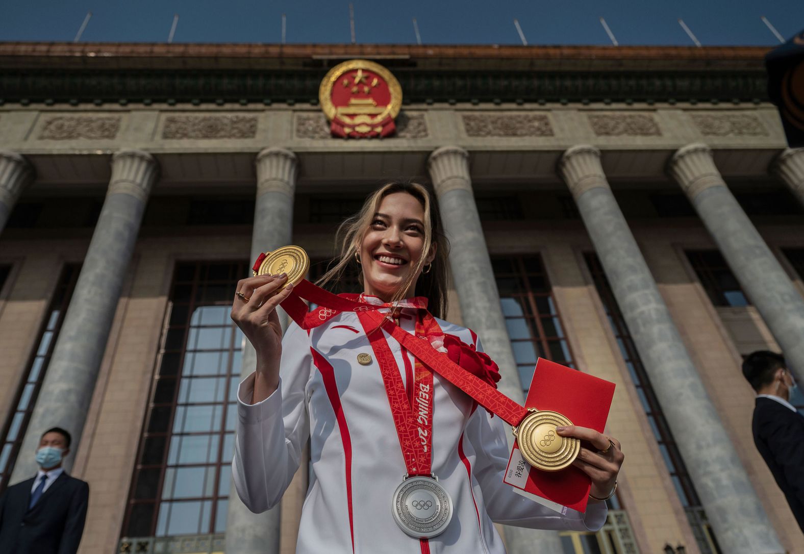 China's Eileen Gu poses with her three Olympic medals before being honored in Beijing on Friday, April 8. The freestyle skier won two golds and one silver during the <a href="index.php?page=&url=https%3A%2F%2Fwww.cnn.com%2F2022%2F02%2F04%2Fsport%2Fgallery%2Fbeijing-winter-olympics-best-photos%2Findex.html" target="_blank">Winter Olympics</a> earlier this year.