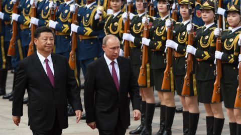 Chinese President Xi Jinping and Russian leader Vladimir Putin review a military honor guard outside the Great Hall of the People in Beijing on June 8, 2018. 
