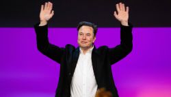 Tesla chief Elon Musk waving onstage at the TED2022: A New Era conference in Vancouver, Canada, April 14, 2022. 