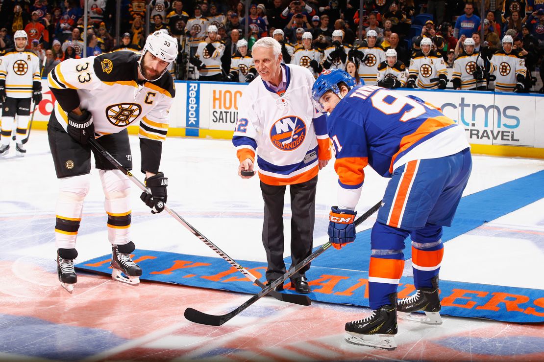 Bossy drops the puck in front of Zdeno Chara of the Boston Bruins and John Tavares of the New York Islanders prior to the game during Mike Bossy tribute night at the Nassau Veterans Memorial Coliseum on January 29, 2015 in Uniondale, New York.  