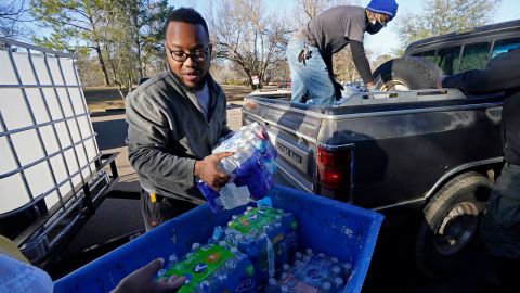 Madonna Manor maintenance supervisor Lamar Jackson, left, stacked bottled water brought by Mac Epps of Mississippi Move last year.