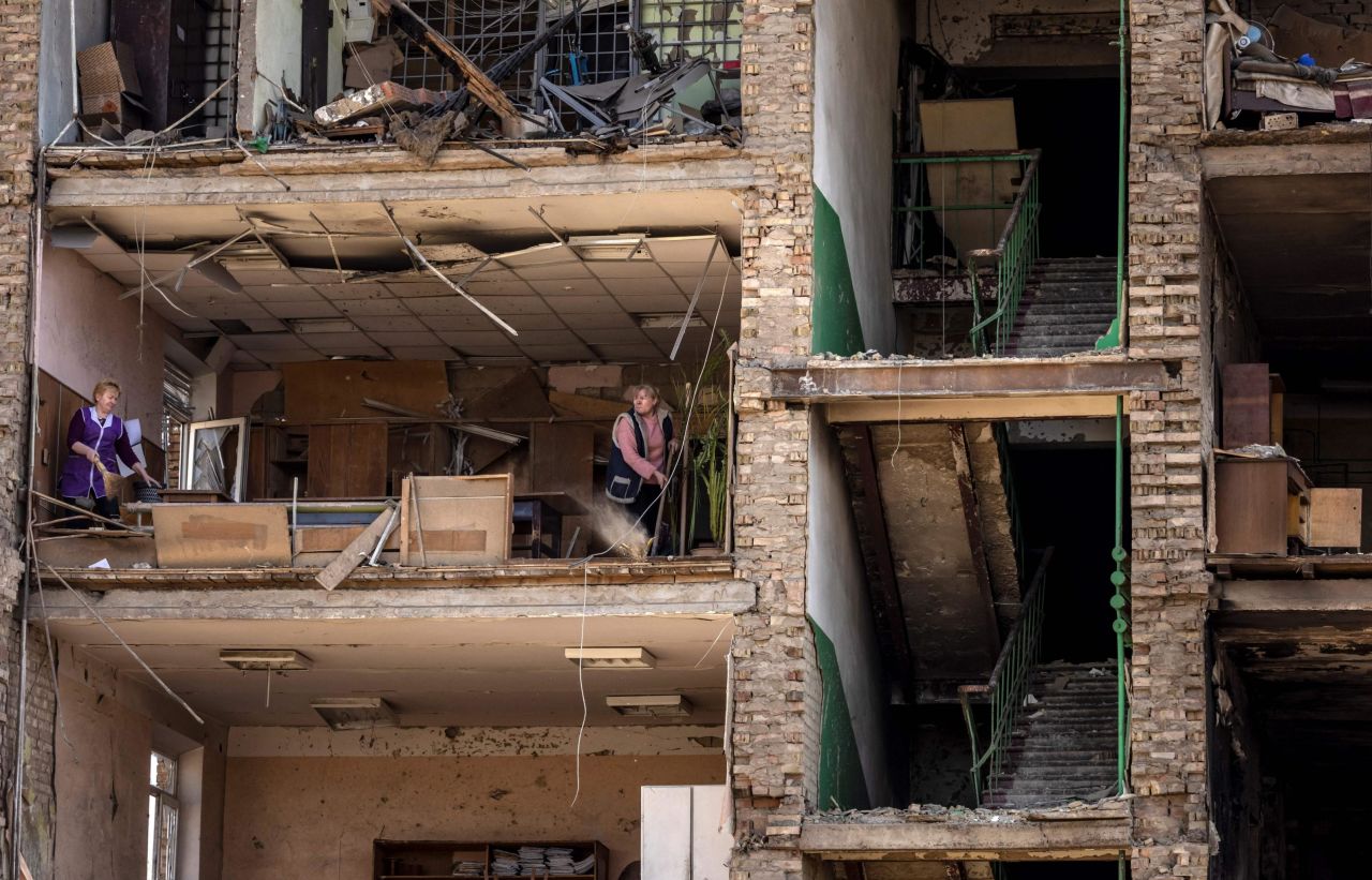 Women clean inside a damaged building at the Vizar company military-industrial complex in Vyshneve, Ukraine, on April 15. The site, on the outskirts of Kyiv, was hit by Russian strikes.