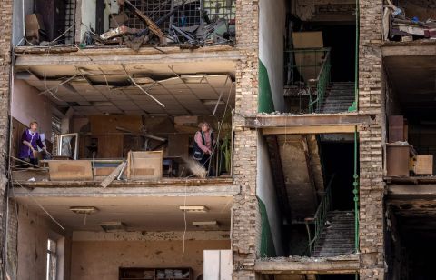 Women clean inside a damaged building at the Vizar company military-industrial complex in Vyshneve, Ukraine, on April 15. The site on the outskirts of Kyiv was hit by Russian strikes.