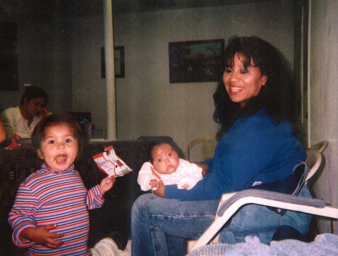 Melissa Lucio holds her daughter Mariah, while daughter Adriana stands next to them.