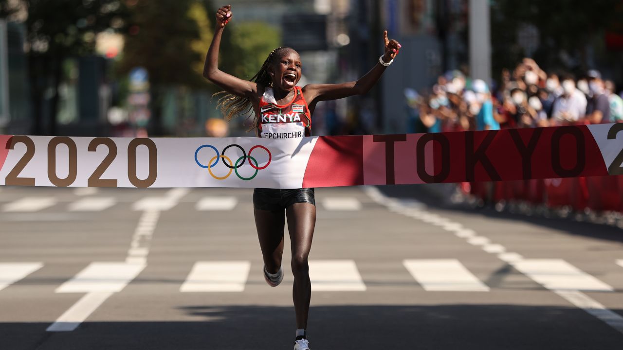 Kenya's Peres Jepchirchir celebrates as she crosses the finish line to win the gold medal in the Women's Marathon Final at the Tokyo 2020 Olympics on August 7, 2021 in Japan.