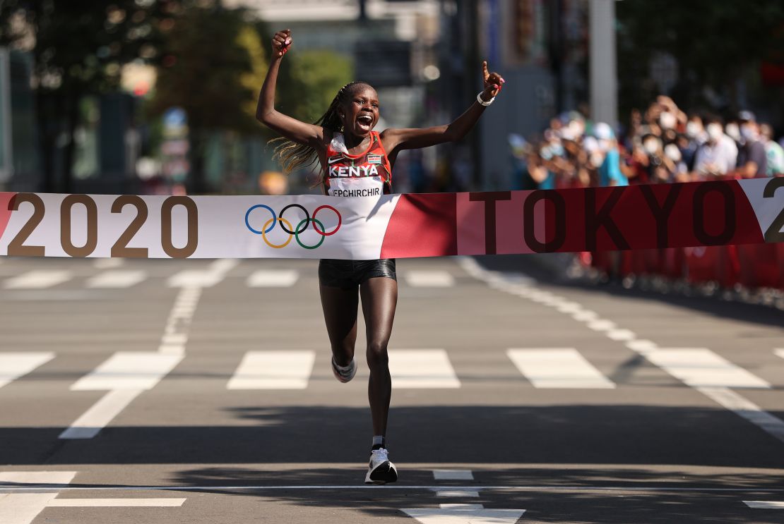 Kenya's Peres Jepchirchir celebrates as she crosses the finish line to win the gold medal in the Women's Marathon Final at the Tokyo 2020 Olympics on August 7, 2021 in Japan.