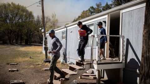 A family leaves their home with a few belongings as they evacuate while the McBride Fire gets closer to their property in Ruidoso, New Mexico, on April 13, 2022.