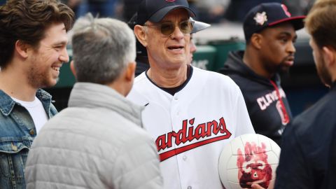 Actor Tom Hanks holds Wilson the volleyball from his film Cast Away before the game between the Cleveland Guardians and the San Francisco Giants at Progressive Field.