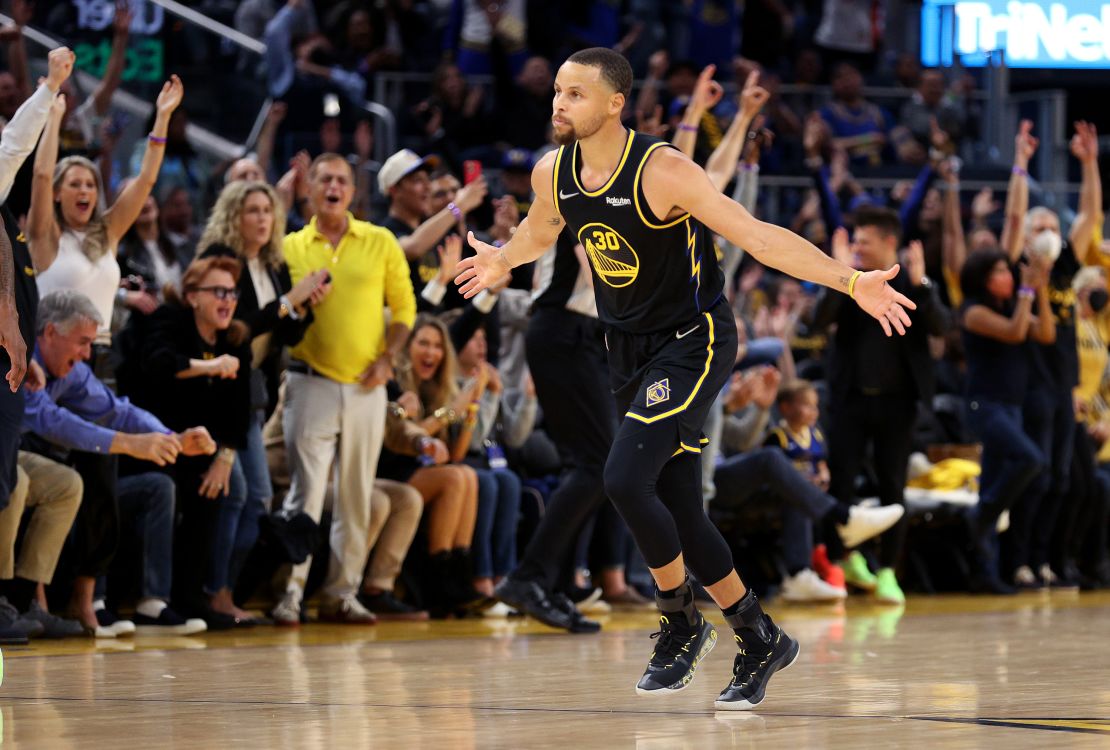 Curry reacts after making a three-point basket against the Nuggets.