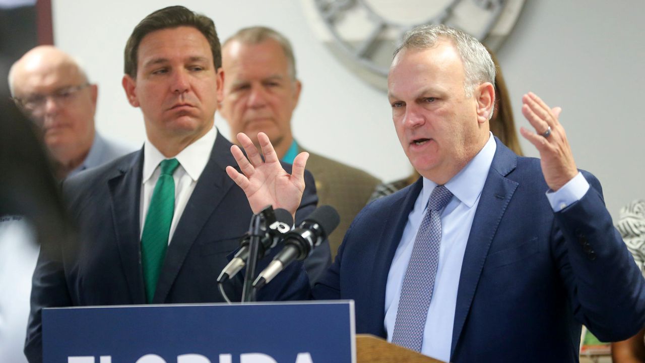 Florida Department of Education Commissioner Richard Corcoran, right, alongside Gov. Ron DeSantis, speaks at a news conference in March.