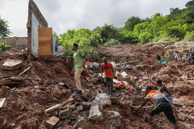 People help clean debris in the Kwandengezi township outside Durban on Friday, April 15.