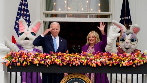 President Joe Biden appears and salutes with first lady Jill Biden and the Easter Bunnies on the Blue Room balcony at the White House during the White House Easter Egg Roll, Monday, April 18, 2022, in Washington. (AP Photo/Andrew Harnik)