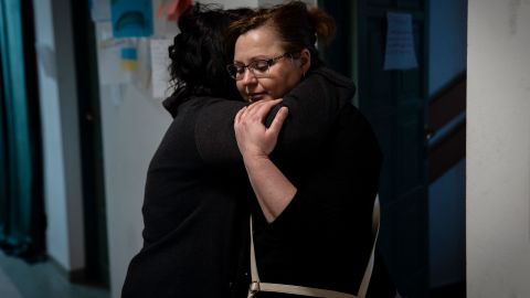 Mila hugs a Ukrainian refugee at the shelter where she volunteers.