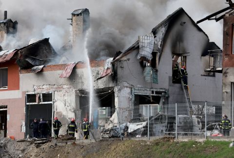 Firefighters work in Lviv after a civilian building was hit by a Russian missile on April 18.