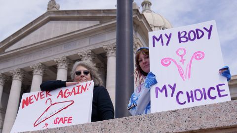 Dani Thayer, left, and Marina Lanae, both of Tulsa, Oklahoma, protest at the state Capitol, Wednesday, April 13, 2022, in Oklahoma City.