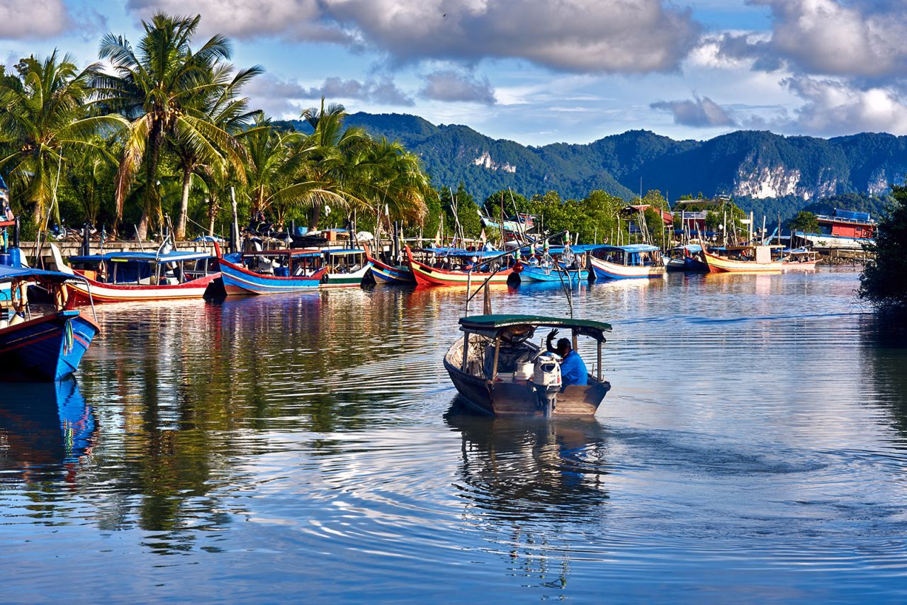 Traditional colorful Asian fishing boats can be spotted on Langkawi island in Malaysia, currently at Level 3.