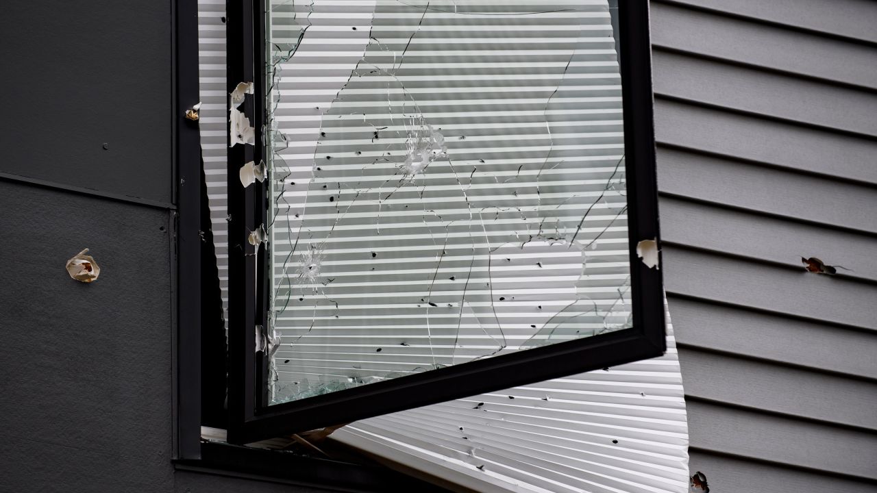 Bullet holes were left in a window at the apartment building where the hundreds ran from gunfire.