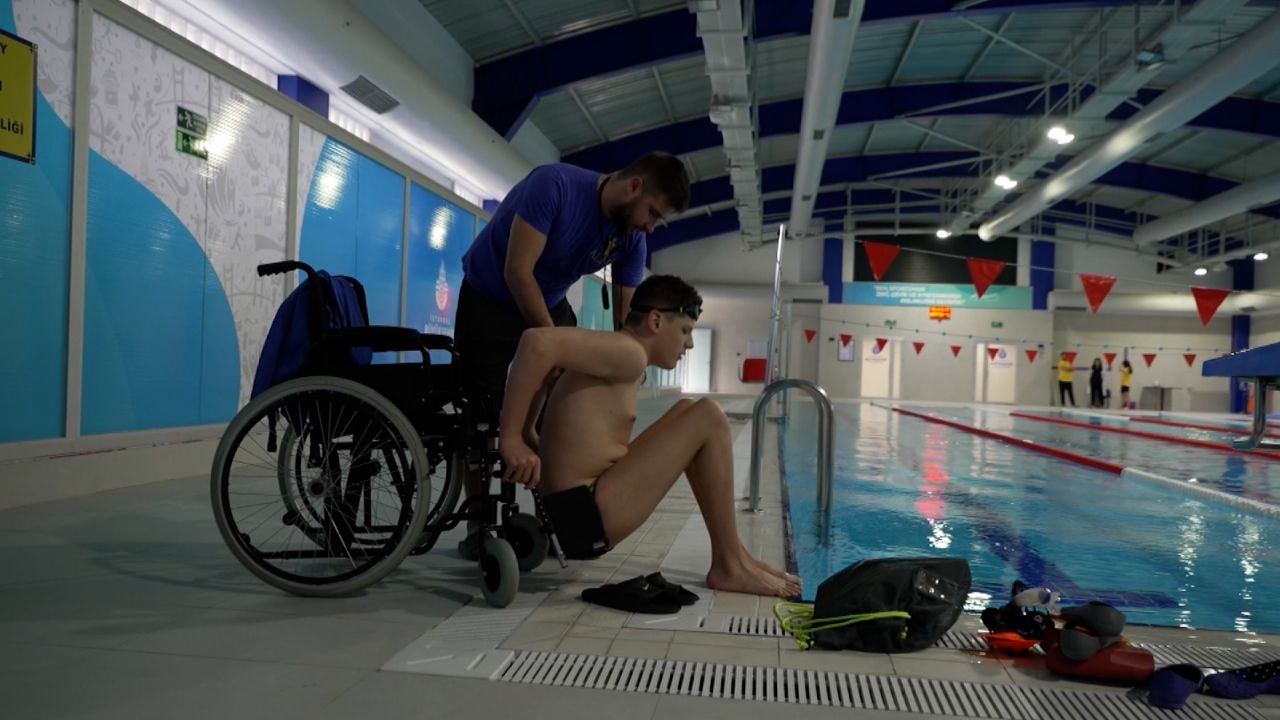 Ilia Sharkov (right) trains with his swimming coach, Ilya Kalashnik (left), at a public pool in Istanbul, Turkey. 
