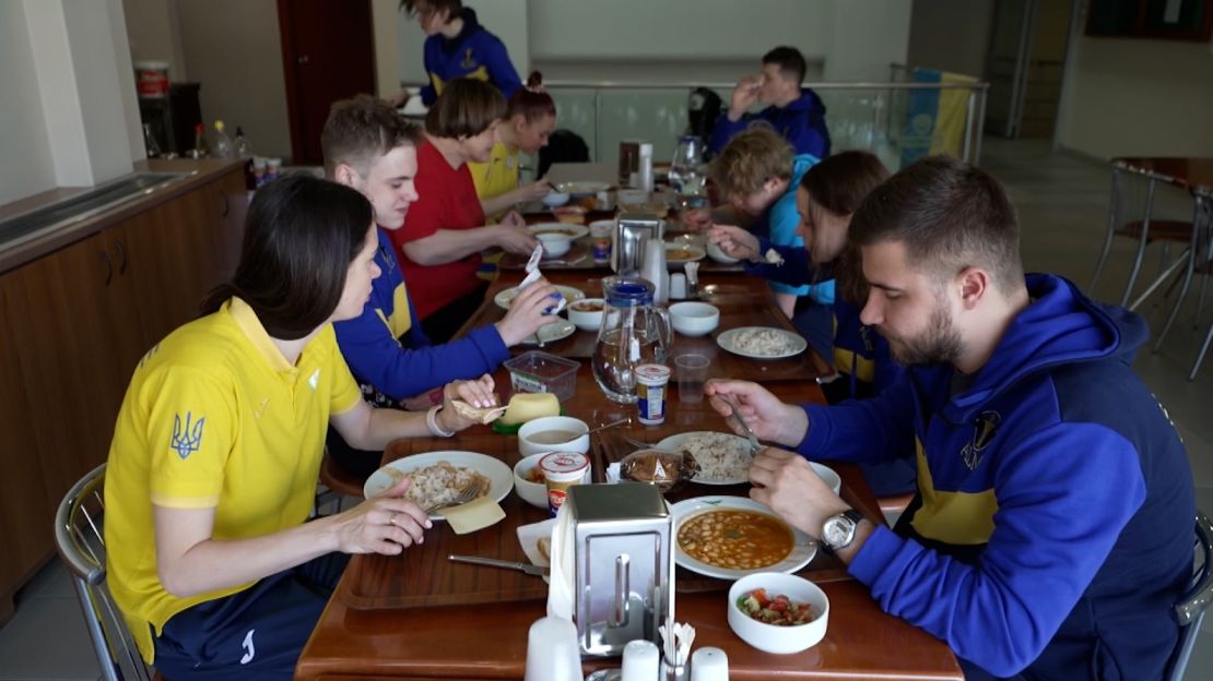 The Ukrainian swim team sits down to eat a meal together at Kasımpaşa SK football club.