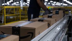 Boxes move along a conveyor belt at an Amazon fulfillment center on Prime Day in Raleigh, North Carolina, U.S., on Monday, June 21, 2021. 