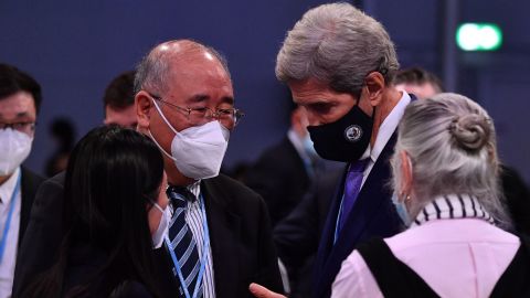 Kerry leans in to speak with China's special climate envoy Xie Zhenhua at the COP26 climate summit in Glasgow in November.