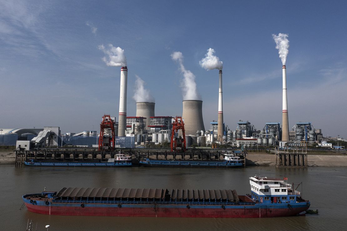 Ships carry coal outside a coal-fired power plant in November 2021 in Hanchuan, Hubei province, China.