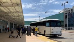 Buses like these drop off hundreds of migrants at the San Antonio airport every day. Inside the airport terminal there are phone charging stations for migrants to charge their devices. 