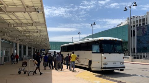 Buses like these drop off hundreds of migrants at the San Antonio airport every day. Inside the airport terminal there are phone charging stations for migrants to charge their devices.
