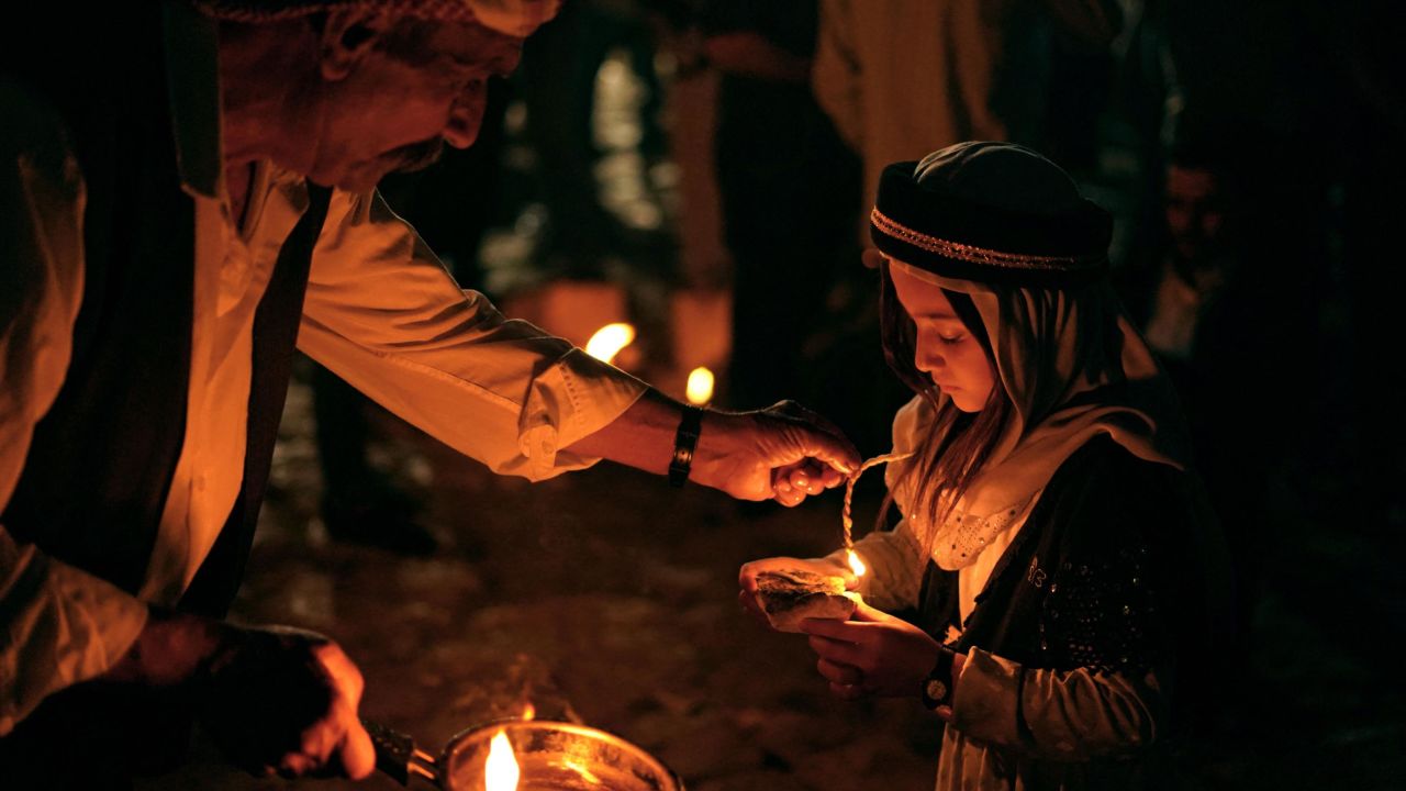 Iraqi Yazidis light candles outside the Temple of Lalish in a valley near the Kurdish city of Dohuk on April 19, during a ceremony marking the Yazidi New Year. The Yazidis, who number about 1.6 million, commemorate the arrival of light into the world during the new year celebrations.