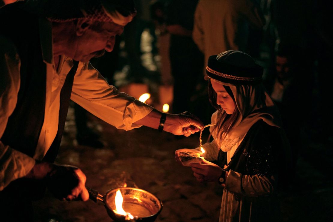 Iraqi Yazidis light candles outside the Temple of Lalish in a valley near the Kurdish city of Dohuk on April 19, during a ceremony marking the Yazidi New Year. The Yazidis, who number about 1.6 million, commemorate the arrival of light into the world during the new year celebrations.