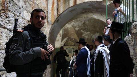 Jewish settlers escorted by Israeli forces enter Al-Aqsa Mosque compound after police drive out Palestinian worshippers following a morning prayer in Jerusalem on April 18.