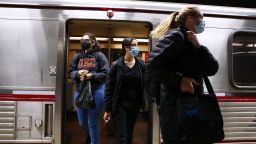 People wear face coverings while departing a Los Angeles Metro Rail train on December 15, 2021 in Los Angeles, California. 