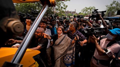 Communist Party of India leader Brinda Karat, center, stands in front of a bulldozer during the demolition of Muslim-owned shops in New Delhi's northwest Jahangirpuri neighborhood, in New Delhi, India, Wednesday, April 20, 2022.