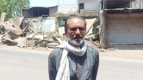 Ayub Khan stands in front of his destroyed shops in Khargone, Madhya Pradesh.
